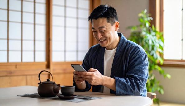 和室でスマホを楽しむ男性のポートレート 和室でスマホを楽しむ男性のポートレートの写真