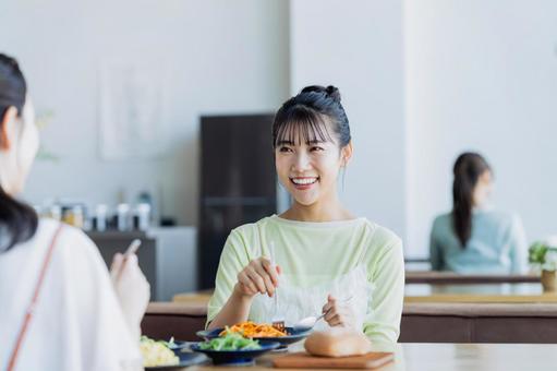 カフェで食事をする若い女性 カフェで食事をする若い女性の写真