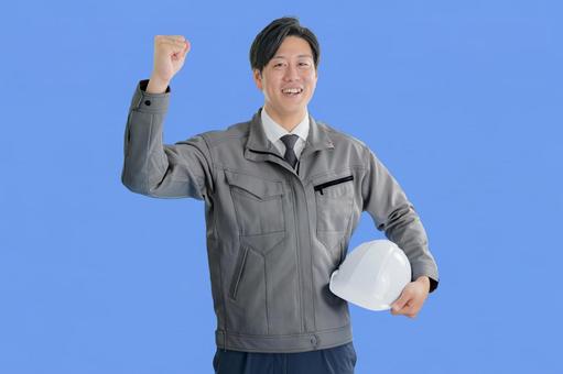 ガッツポーズする爽やかな作業員 作業員,作業着,工業の写真素材