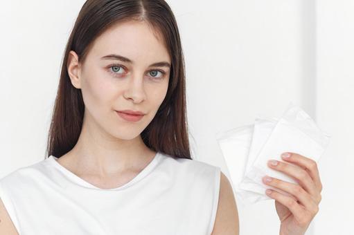 生理用ナプキンを持つカメラ目線の女性 生理,月経,女性の写真素材