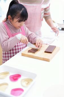 板チョコを細かく刻むクッキングシーン 女の子,チョコレート,包丁の写真素材