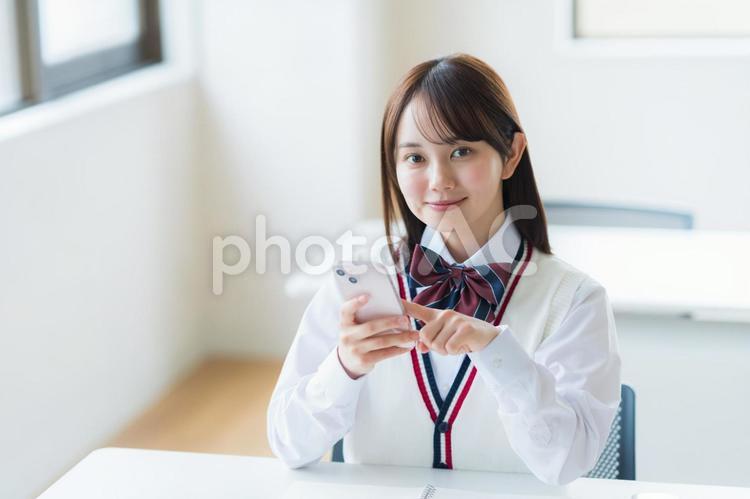 教室で勉強する学生 高校生,スマホ,笑顔の写真素材