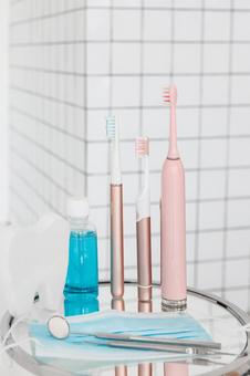 ピンクの並んだ電動歯ブラシとマスクなど ピンクの並んだ電動歯ブラシとマスクなど 歯ブラシ,歯磨き,洗口液の写真素材