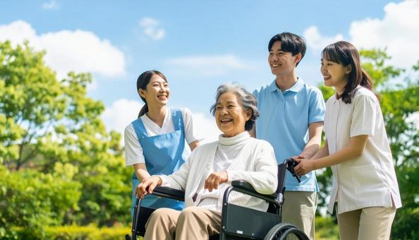 車椅子のシニア女性と車椅子を押すヘルパー 車椅子のシニア女性と車椅子を押すヘルパーの写真