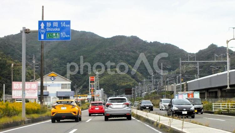  E1東名10kmの看板と新幹線列車通過 道路,黄色い車,車の写真素材