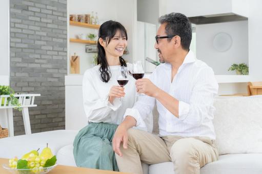 リビングでワインを飲むミドルの夫婦 夫婦,家族,乾杯の写真素材