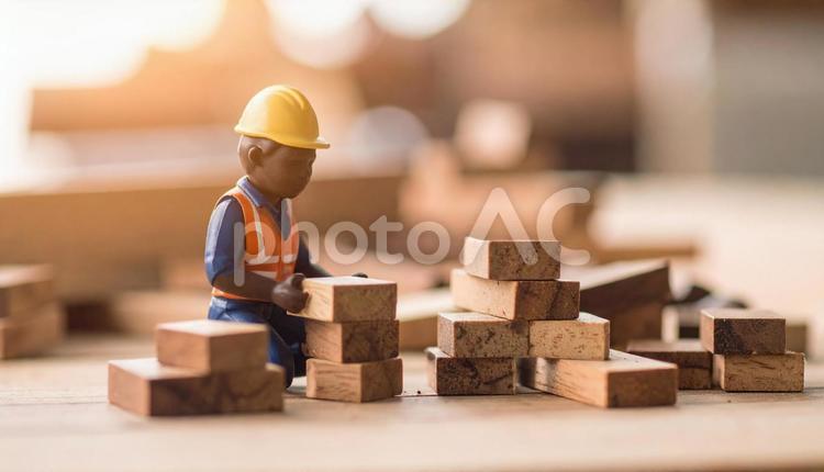 建設現場で働く建設作業員のフィギュア人形 建設現場,安全服,クレーンの写真素材