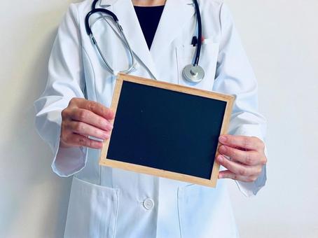 Female doctor holding a blackboard, JPG Female doctor holding a blackboard, JPG