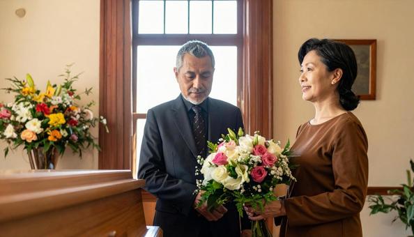 棺を見つめるミドルの男女の写真