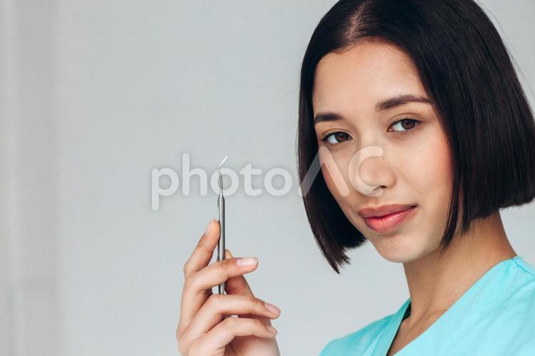 医療器具を持ってポーズする女性 女性,歯科医,1人の写真素材