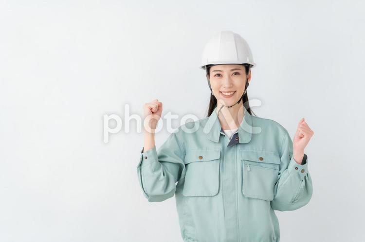白バックの作業服のビジネスウーマン 不動産,建築,ビジネスの写真素材