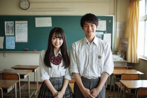 教室に立つ高校生男女のイメージの写真
