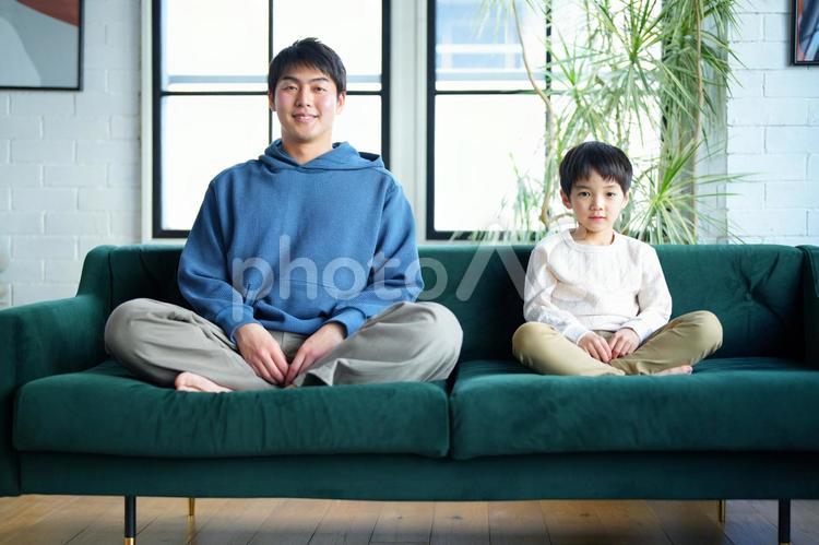 あぐらでカメラ目線の親子 親子,男の子,小学生の写真素材