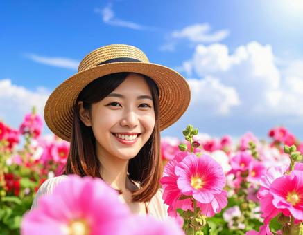 タチアオイの花と彼女 タチアオイの花と彼女の写真