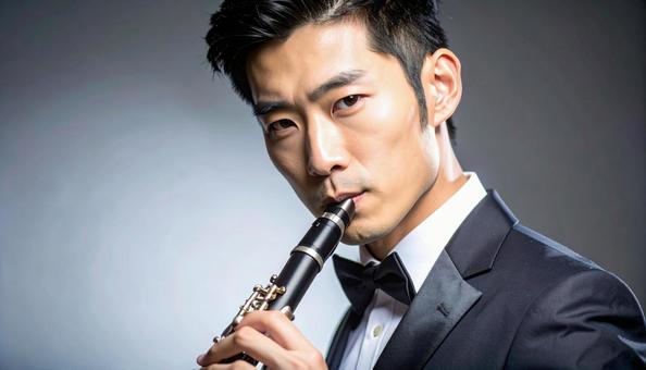 ファゴットを演奏するアジア人男性の写真