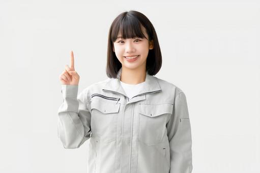 作業服を着て案内をする若い女性 女性,ビジネス,作業服の写真素材