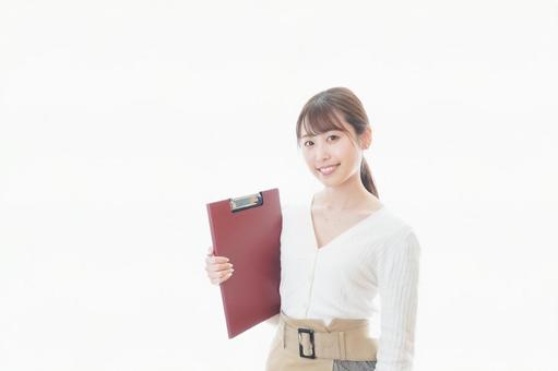 笑顔で資料を持つ若い女性 テスト,個人情報,白背景の写真素材