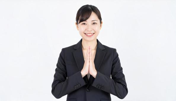 両手をあわせてお願いするビジネスウーマン 両手をあわせてお願いするビジネスウーマンの写真
