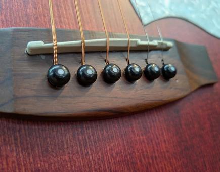 アコースティックギターのブリッジピン ギター,アコースティックギター,アコギの写真素材