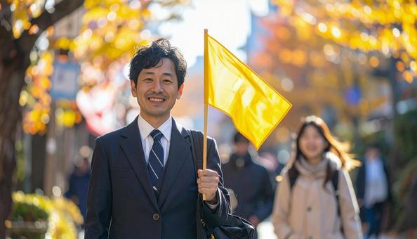 旗を持って旅行客を導く男性の旅行添乗員 旗を持って旅行客を導く男性の旅行添乗員の写真