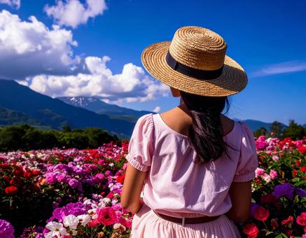 青空と花畑と女性２の写真