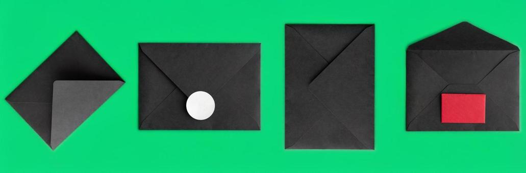緑背景に黒い封筒が並ぶ 緑背景に黒い封筒が並ぶの写真