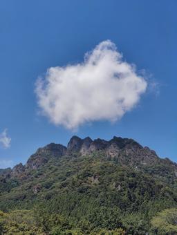 妙義山と白い雲が浮かぶ青い空(縦) 妙義山と白い雲が浮かぶ青い空(縦)の写真