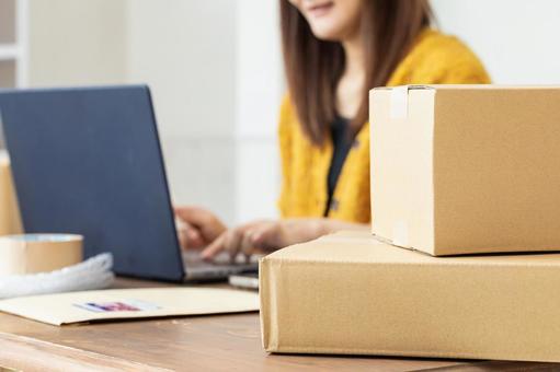 荷物の発送準備をする女性 配送,配達,段ボールの写真素材
