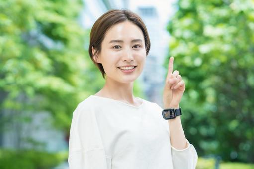 A woman posing to raise her index finger, female, casual, pause, JPG