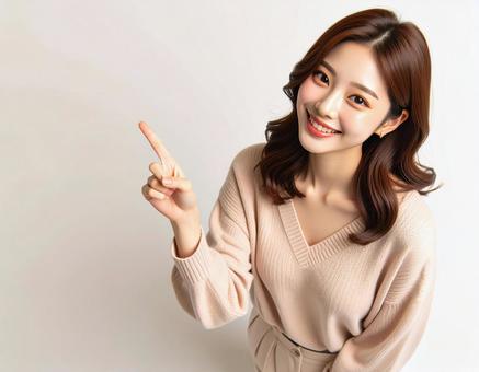 横を指差す女性 横を指差す女性の写真