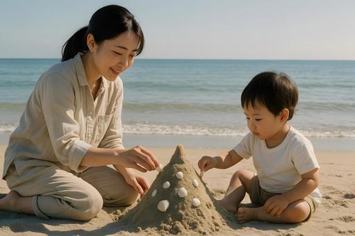 砂浜で砂遊びする親子 砂浜で砂遊びする親子の写真