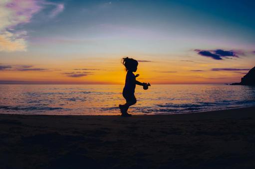 Film-style silhouette of a child running along the coastline, JPG