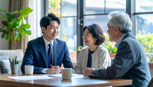 男性営業マンの説明を聞く夫婦 男性営業マンの説明を聞く夫婦の写真