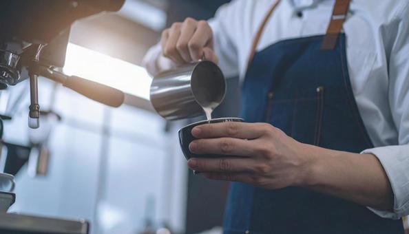 コーヒーラテアートを描くスタッフの手もとの写真