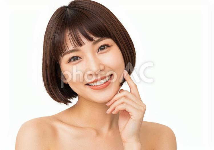 頬に指をあて微笑むショートボブの若い女性 笑顔,ショートボブ,若い女性の写真素材