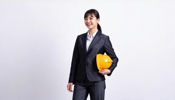 ヘルメットを抱え笑顔の若い日本人女性 ヘルメットを抱え笑顔の若い日本人女性の写真