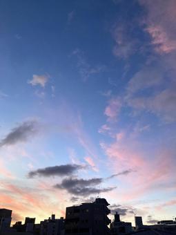 夏の夕暮れ、青空とピンク色の雲とビルの影 夏の夕暮れ、青空とピンク色の雲とビルの影の写真