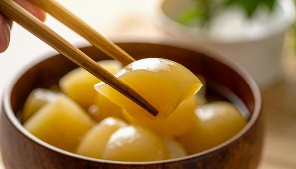 大根の煮物を箸でとる 大根の煮物を箸でとるの写真