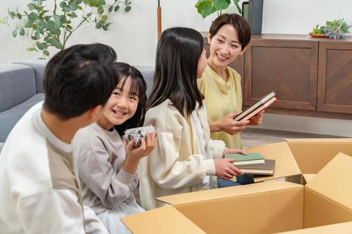 ダンボールに物を入れる家族 ダンボールに物を入れる家族 家族,引っ越し,引越しの写真素材