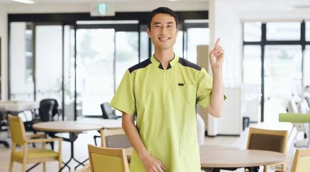 介護施設で指差しをするアジア人介護福祉士 介護施設で指差しをするアジア人介護福祉士 介護福祉士,介護士,指差しの写真素材