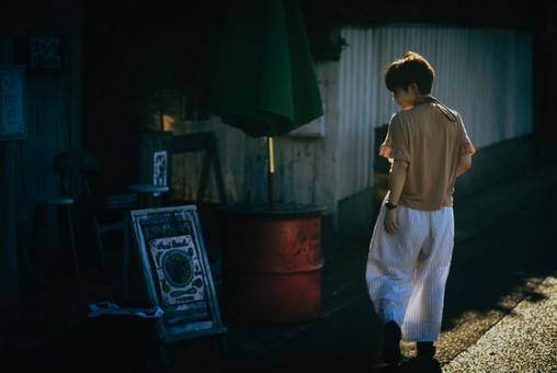 <Material> A woman strolling around a tourist spot at dusk, JPG