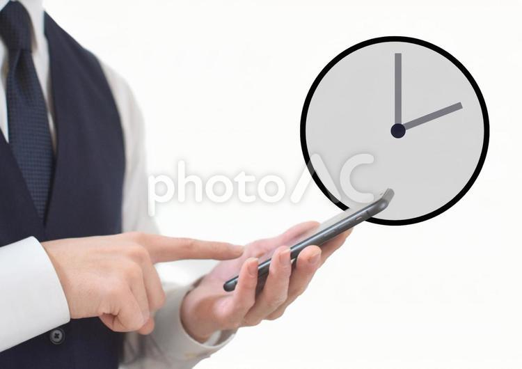 スマホ操作するビジネスマンと時間 時計,時間,予定の写真素材