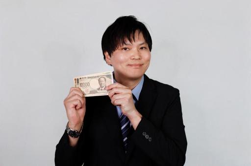 万円札を持つ男性 万円札を持つ男性 男性,スーツ,お金の写真素材