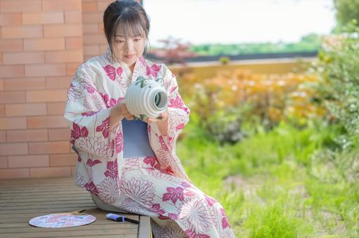 A woman in a yukata with mosquito coils, JPG