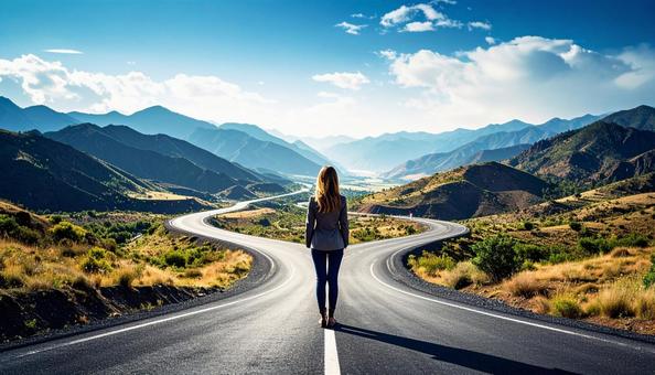 どちらへ進むか考える女性の後ろ姿の写真