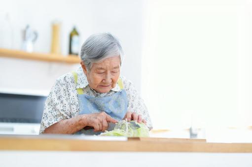 キャベツを千切りしているおばあちゃん 女性,キャベツ,包丁の写真素材