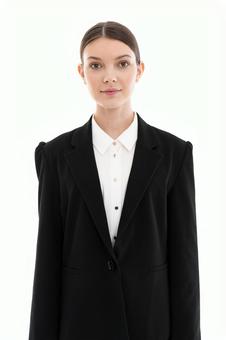 A woman in a suit smiling at the camera, JPG