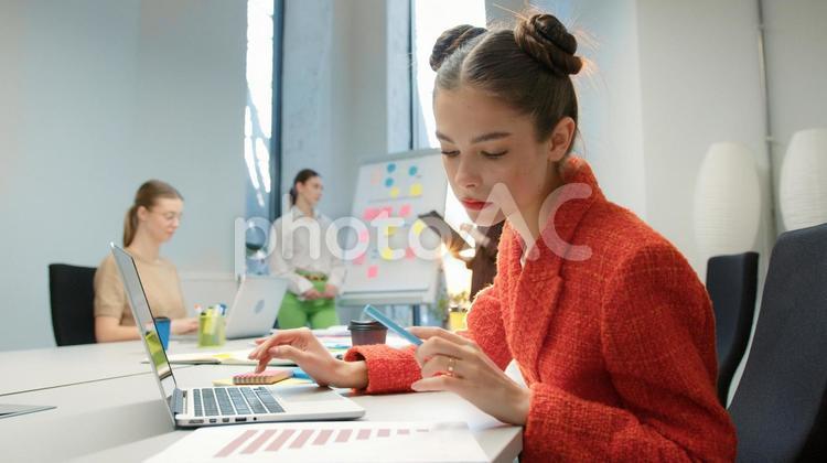 資料を見ている女性と話し合っている同僚 ビジネス,ビジネスマン,ビジネスウーマンの写真素材