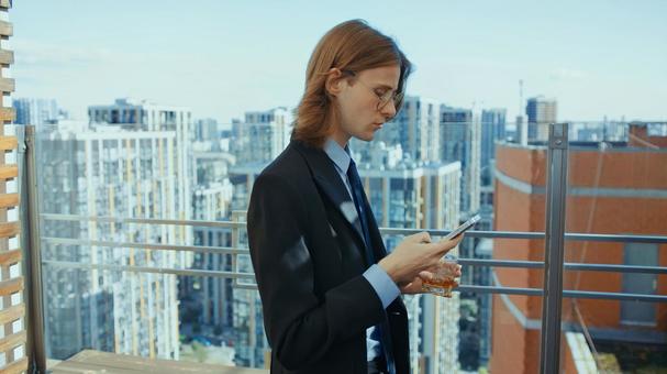 横向きでスマホを見ている長髪の男性 男性,外国人,スマートフォンの写真素材