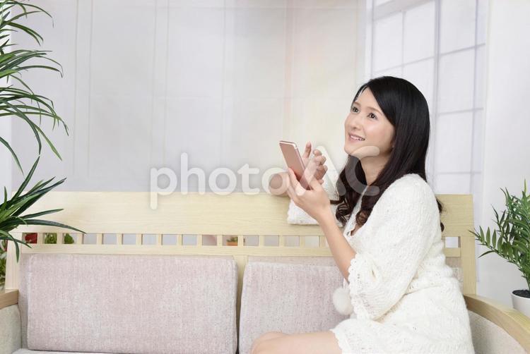 スマートフォンを持つ笑顔の女性 女性,スマートフォン,女の写真素材